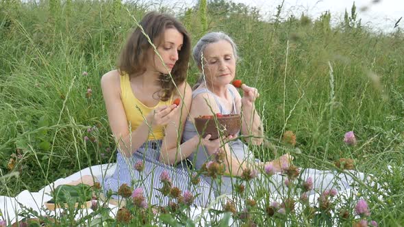 Beautiful Old Grandmother with Grey Hair and Face with Wrinkles is Lying on White Carpet with Her alt