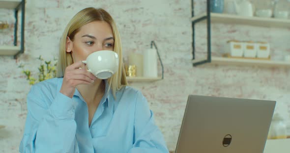 Young Woman Drinking Coffee and Making Video Call on Laptop, Smiling Girl in Talking To Webcam