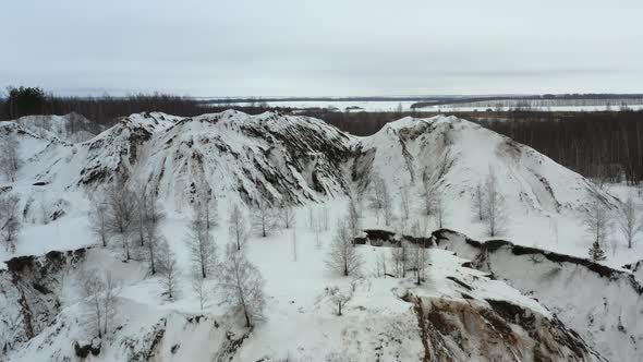 Flying above the abandoned quarry in winter