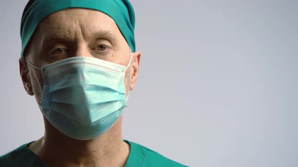 Serious Face of Surgeon in Medical Face Mask Looking to Camera, Health Insurance alt