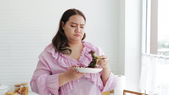 Sad Fat woman eating salads for dieting weight loss. healthy food choice, diet