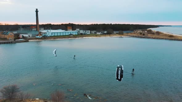 Aerial Drone View of a Corekites Kitesurfers Hydrofoiling  in Engure Port at in Baltic Sea alt
