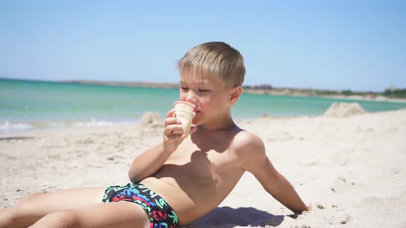 Cute Boy on the Beach Eating Ice Cream