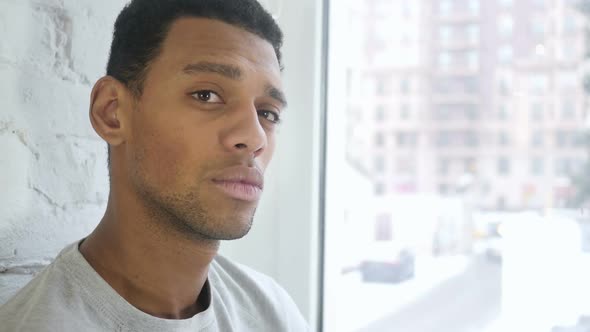 Close Up of AfroAmerican Young Man Looking Toward Camera alt