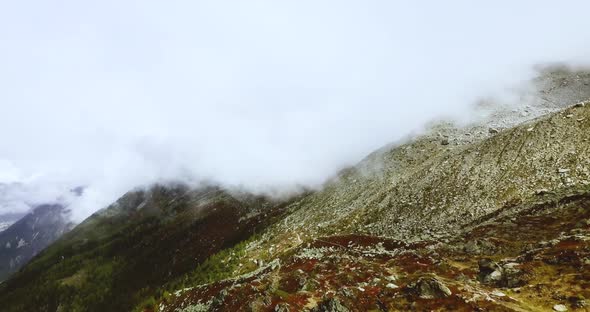 Mountain Foggy Valley. Misty Alps Landscape. Snowy Hazy Peaks in Brumous Cloudy Chamonix. Northern