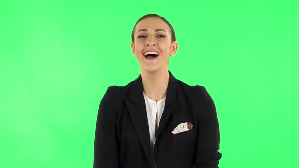 Girl Listens Carefully Then Bursts Into Laughter. Green Screen alt