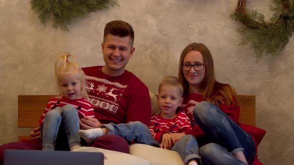 Happy Family Watching Movie Together at Christmas