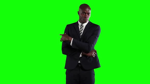 an African American man in suit in green background