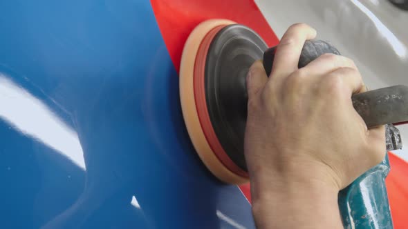 Man's Hand Hold a Rotating Polish Machine and Clean the Wall of Subway Car