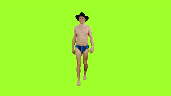 Walking Young Man in Swim Trunks and Cowboy Hat 
