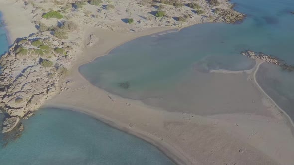 Aerial view of a walking woman on a idyllic paradise beach. Long shot alt