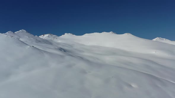 Snow covered mountains and blue sky alt