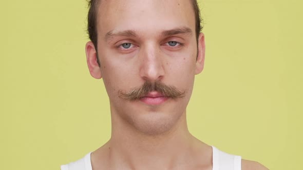 in Slow Motion Closeup No Ordinary Guy Joyfully Playing with Eyebrows Smiling and Blinking alt