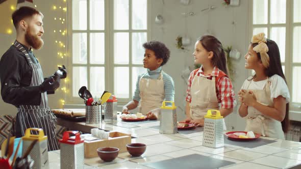 Kids Listening to Chef and Clapping Hands on Culinary Masterclass alt