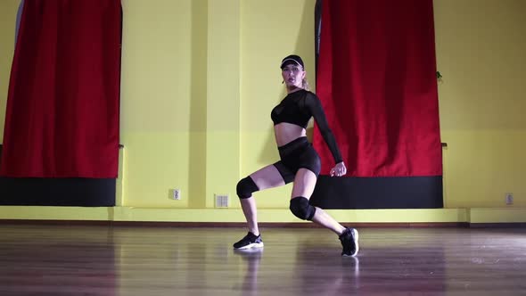 Sexy Dancing  Blonde Tattooed Woman in Translucent Suit and a Cap Dancing in Yellow Studio alt