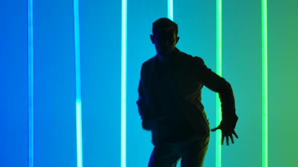 Complex Elements of Break Dance Performed By a Professional Dancer in a Dark Studio Against a alt