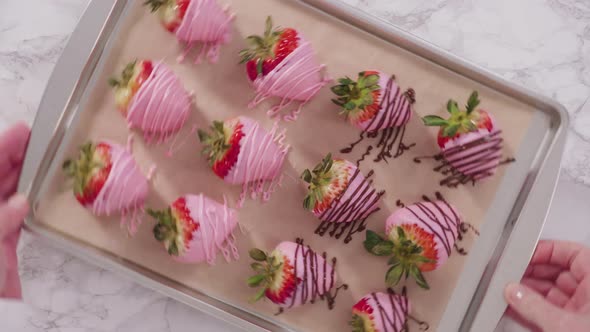 Flat lay. Step by step. Variety of chocolate dipped strawberries on a parchment paper. alt