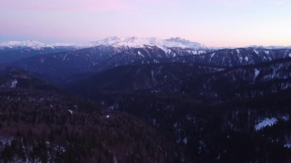 View of the beautiful snow-capped mountains on a winter day. Drone camera.