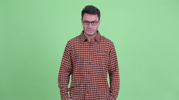 Stressed Young Hispanic Hipster Man Looking Around alt
