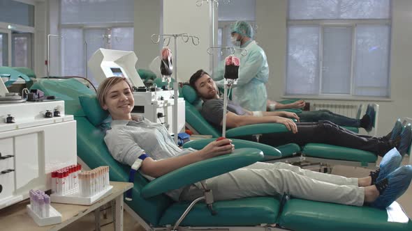 Young Blood Donors Looking at Camera with Smile alt
