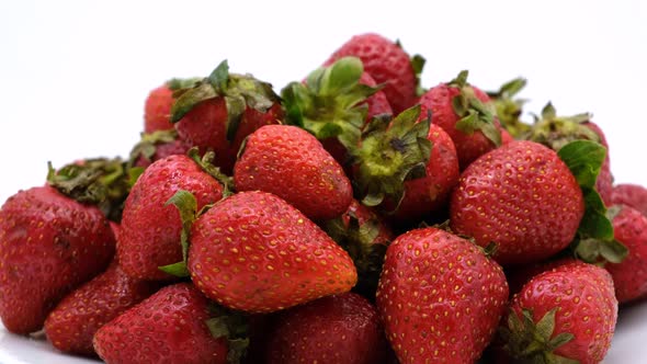 Strawberries rotating on a white background. Strawberry ripe season