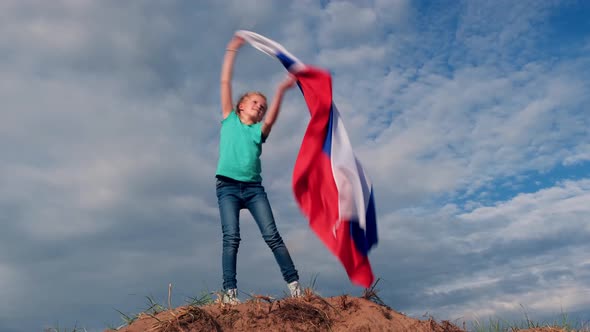 Blonde Girl Waving National Russia Flag Outdoors Over Blue Sky at Summer Russian Flag Country alt