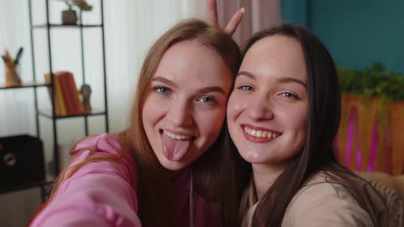 Two Women Friends Siblings Bloggers at Home Laughing Spend Leisure Time Taking Selfie Pictures alt