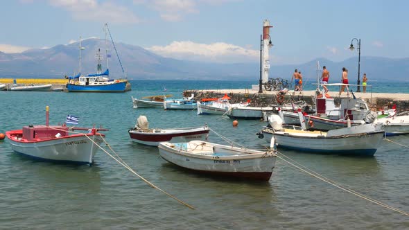 Fishing Boats Near the Pier on Greek Island. Traveling Concept. Tourism Background. Sailing Boats