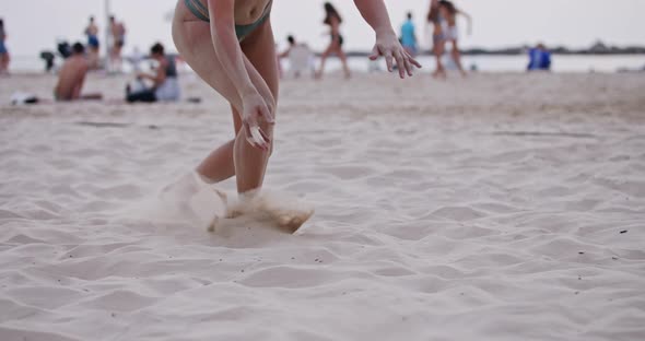 Female Beach Volleyball player diving on the sand during a game alt
