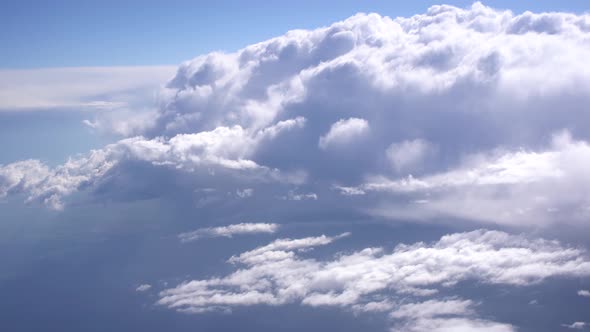 White Thick Heaping Clouds in the Blue Sky alt