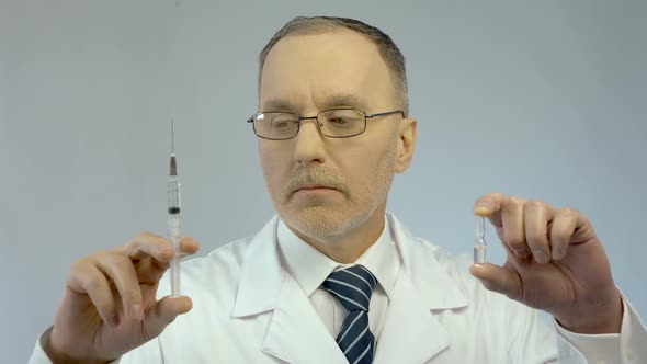 Doctor Holding Syringe and Ampoule, Prescribing Effective Medication to Patient alt