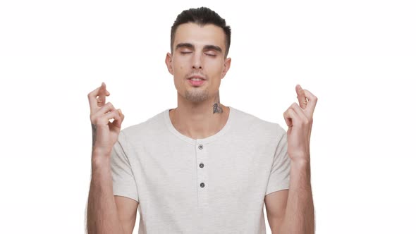 Horizontal Portrait of Muscular Tattooed Man Wearing Casual Shirt Wishing Something Good Looking Up alt