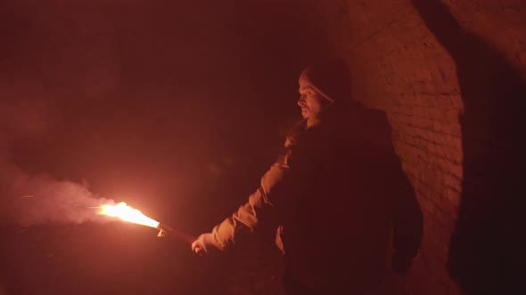 Scared Digger Guy with Red Flare Torch walking through Medieval Dungeon Tunnel