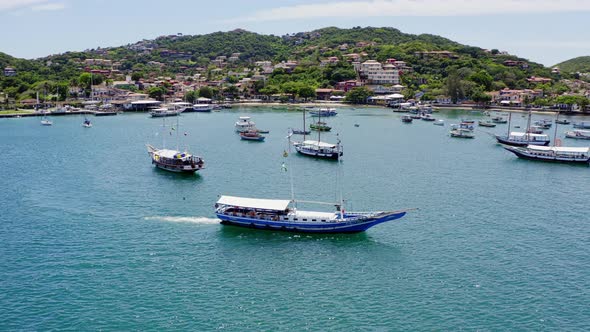 Aerial shot of Buzios coast and boats sailing Brazil alt