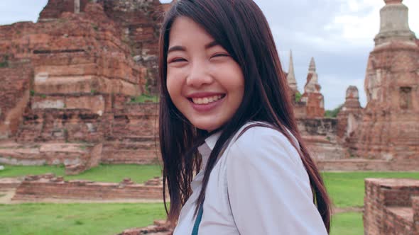 Asian backpacker blogger woman casual with camera take photo smiling traveling.
