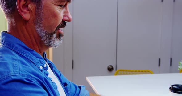 Male executive working at desk alt