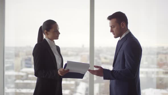 Cheerful Businesswoman Discussing Work with Businessman alt
