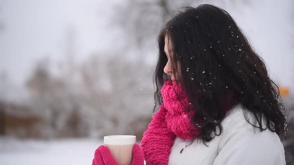 Young Woman Drinking Tea In Winter