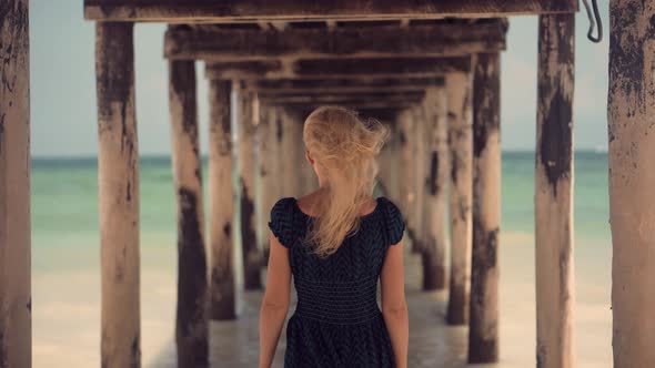 Summer Holiday Travel Vacation Adventure. Tourist Girl Walking On Beach. Tanned Woman In Dress. alt