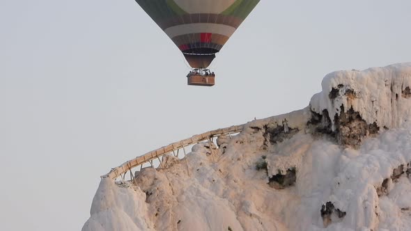 Hot Air Balloons in White Travertines of Pamukkale, a Touristic Natural World Heritage Site