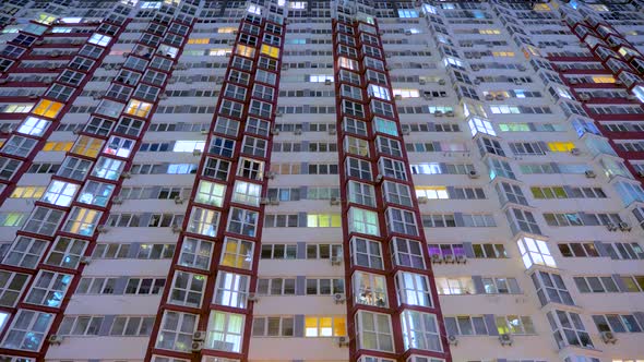 Time Lapse. Apartment Houses Bottom View. The Lighting in the Windows Are Switched on and Off. alt