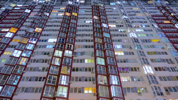 Time Lapse. Apartment Houses Bottom View. The Lighting in the Windows Are Switched on and Off.