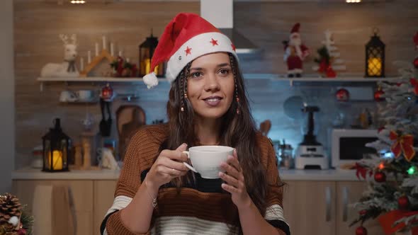 Happy Woman with Santa Hat Thinking About Christmas Time alt