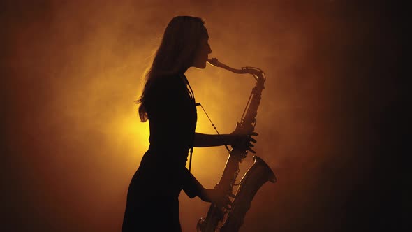 Silhouette of Girl Playing Saxophone