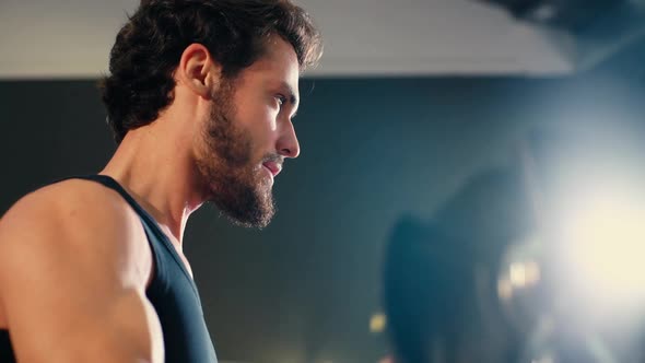 Close-up of Face of Young Man with Muscular Body Doing Exercise with Weights. alt
