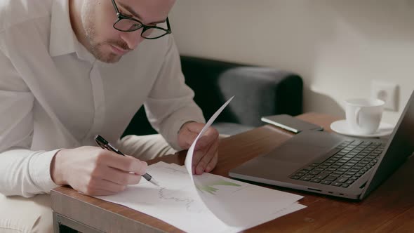 Businessman in Glasses Signs Important Documents