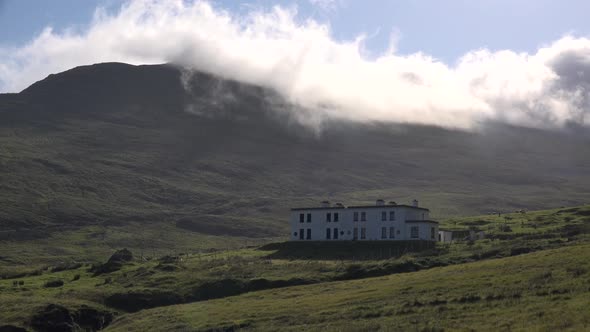 Misty clouds flowing over a mountain in Ireland.