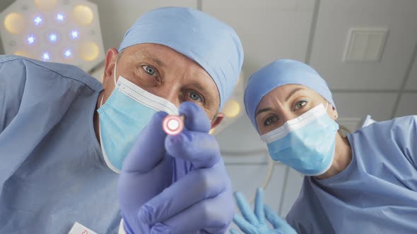 Surgeon Checks the Reaction of the Patient's Pupils with a Flashlight alt