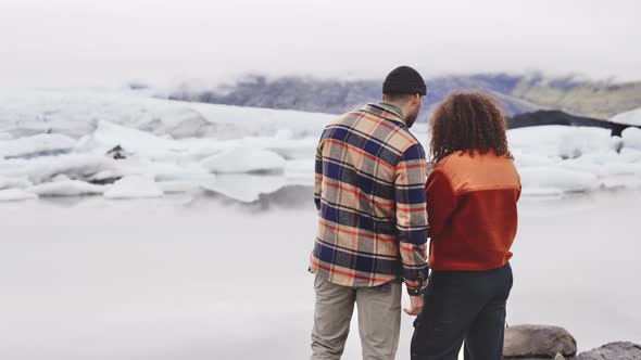 Tourist Travelers with Beautiful View of Iceland Glacial Field in Background alt