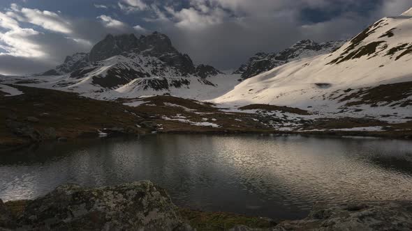 Time-lapse of Clouds Snow-capped Mountains and a Lake 